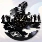 Wall clock featuring cut-out silhouettes of soldiers, futuristic vehicles, and a central clock face, all appearing to be made from a repurposed vinyl record.